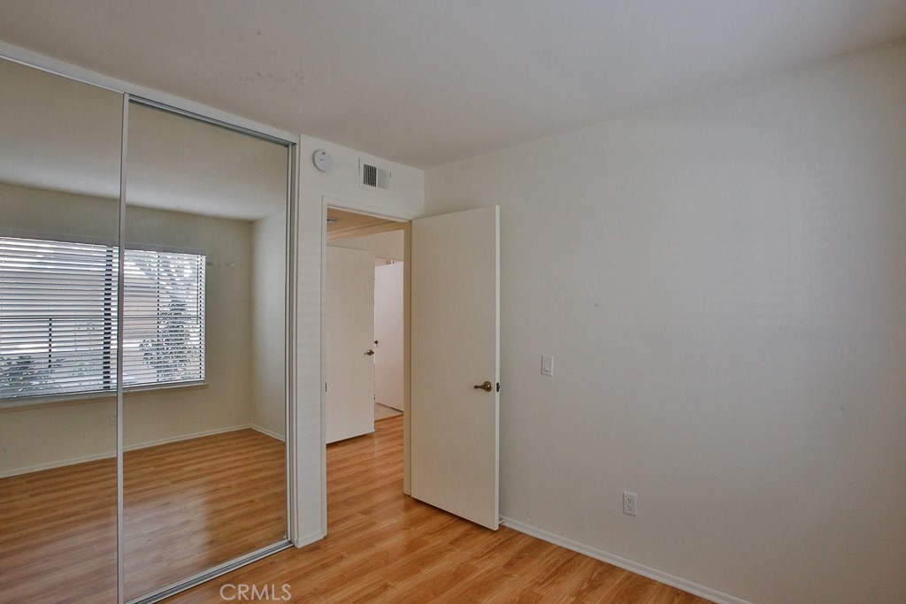 12635 Briarglen Loop, Unit G Stanton, CA 90680 - Photo 6 of 19 a view of wooden floor and windows in a room