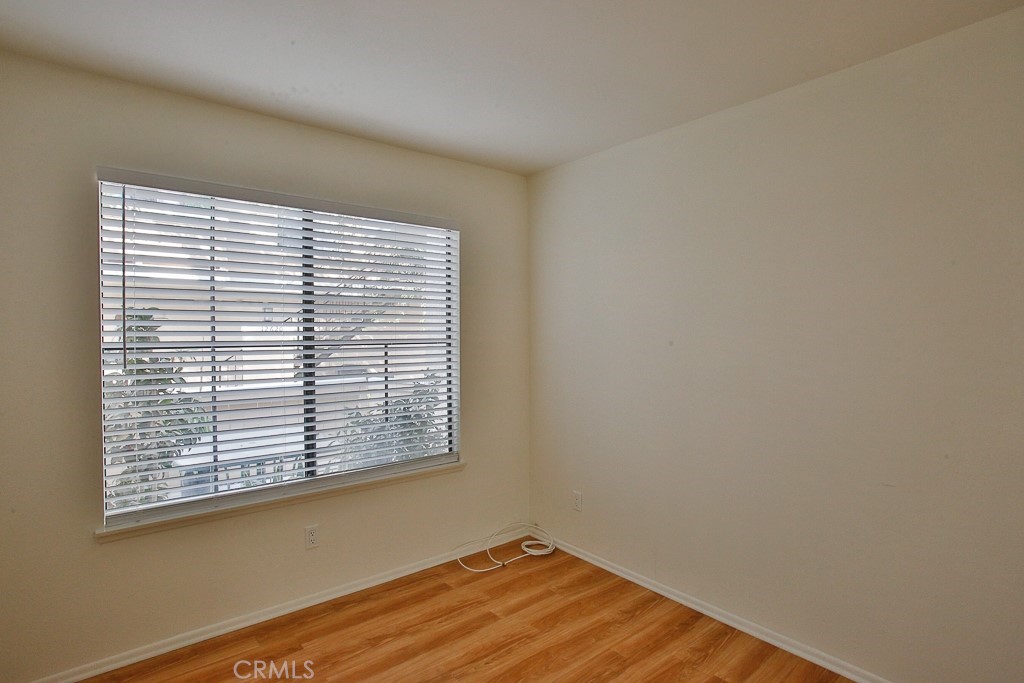 12635 Briarglen Loop, Unit G Stanton, CA 90680 - Photo 7 of 19 an empty room with wooden floor and a window