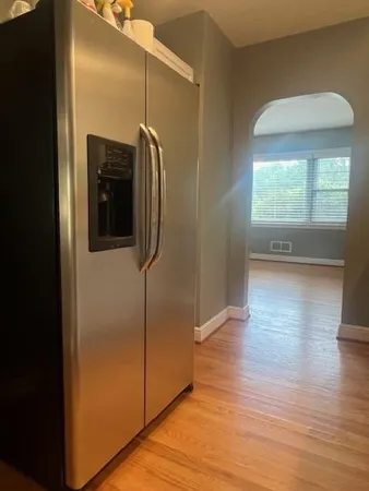 a view of a hallway with wooden floor