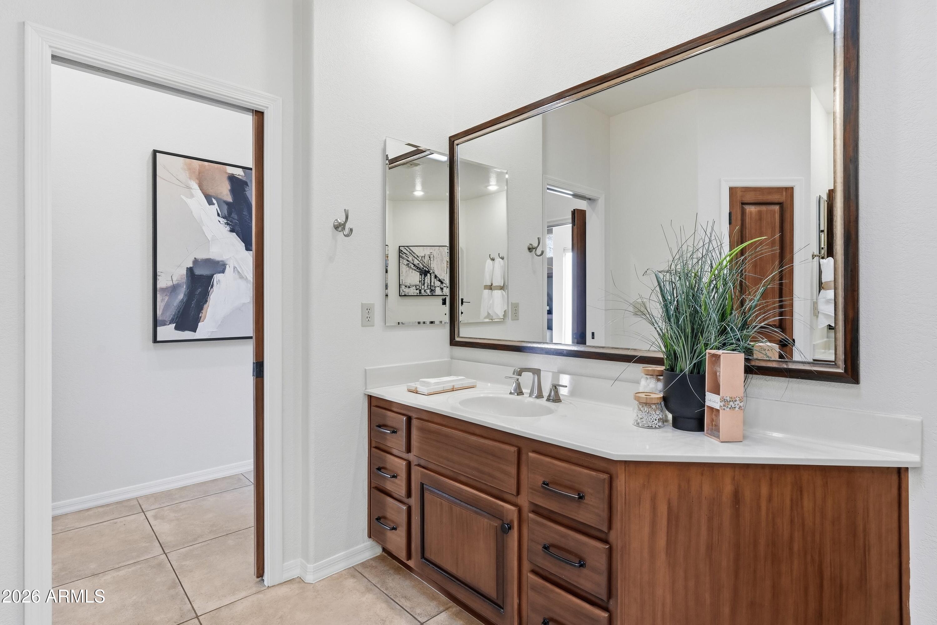 18602 Amarado Circle Rio Verde, AZ 85263 - Photo 33 of 58 a bathroom with a double vanity sink a mirror and shower