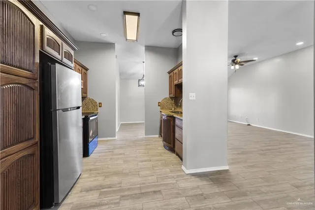a kitchen with stainless steel appliances a refrigerator and a stove