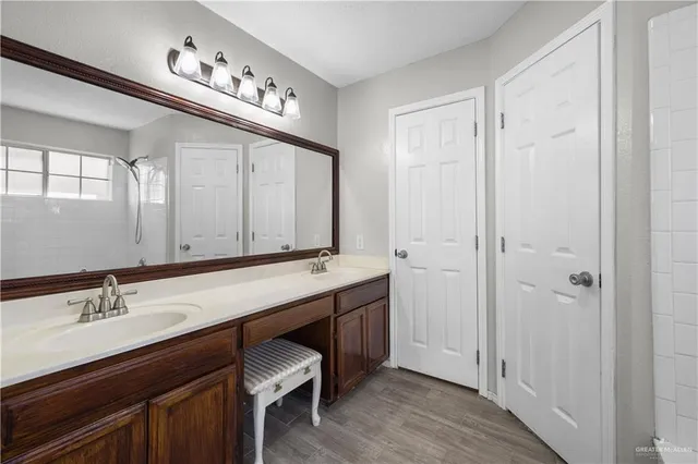 a bathroom with a double vanity sink and a mirror
