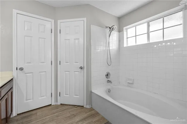 a bathroom with a bathtub and a shower