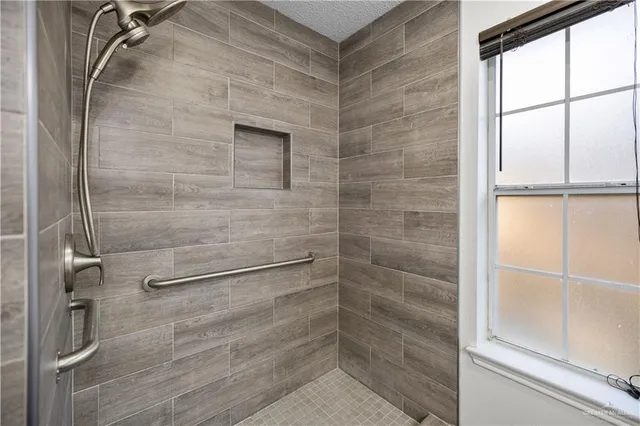 a bathroom with a glass door shower