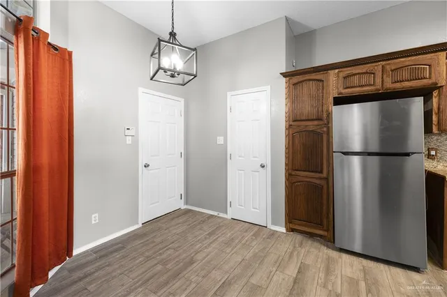 a view of a refrigerator in kitchen and wooden floor