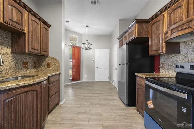a kitchen with stainless steel appliances granite countertop a stove and a sink