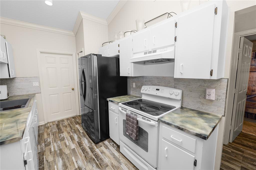 225 Lindale Street Lakeland, FL 33809 - Photo 11 of 37 a kitchen with a stove and a refrigerator