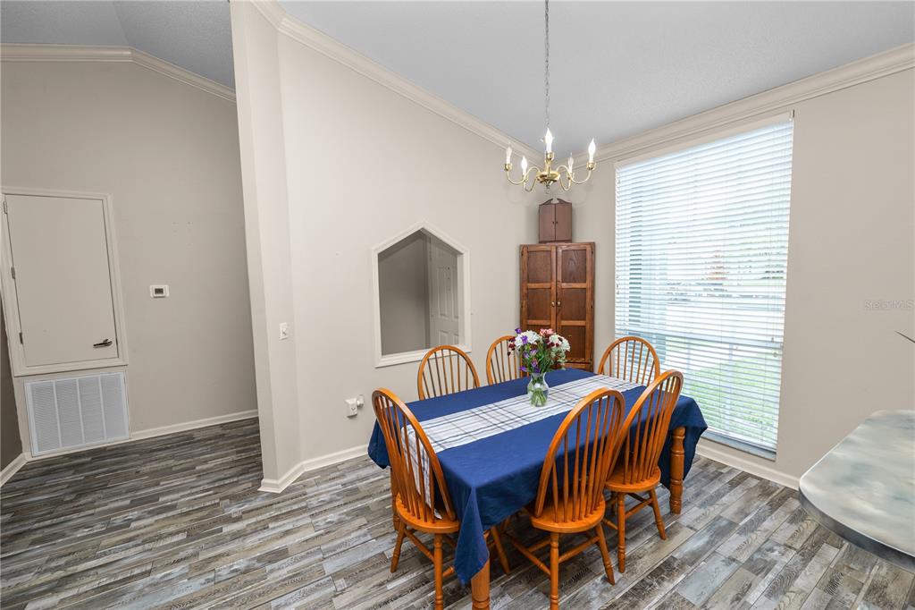 225 Lindale Street Lakeland, FL 33809 - Photo 16 of 37 a view of a dining room with furniture window and wooden floor