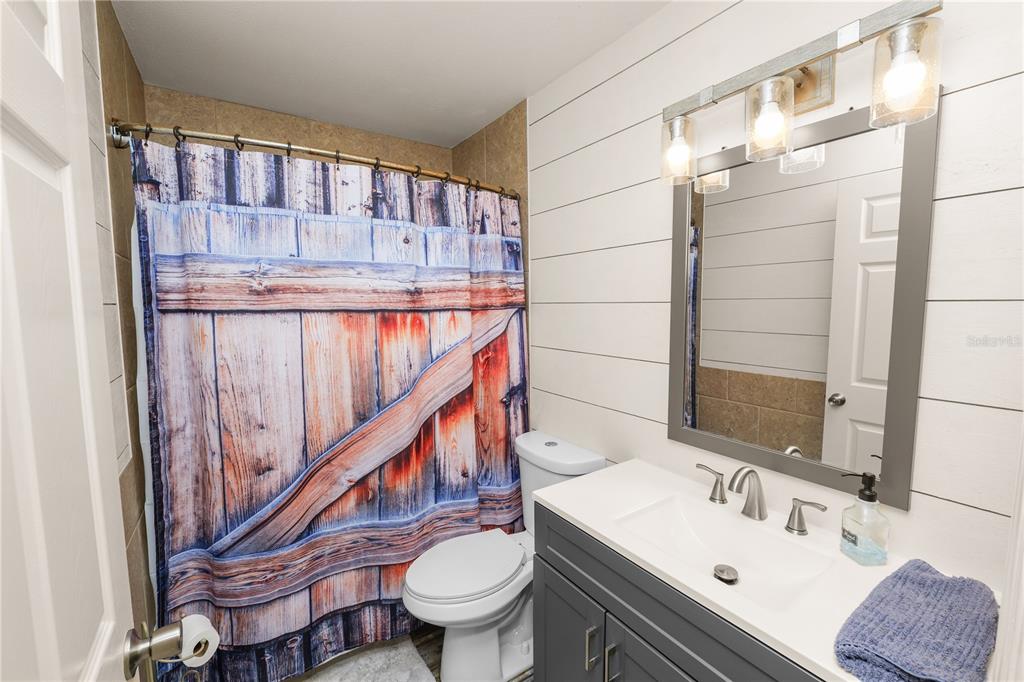 225 Lindale Street Lakeland, FL 33809 - Photo 24 of 37 a bathroom with a sink a toilet and a mirror
