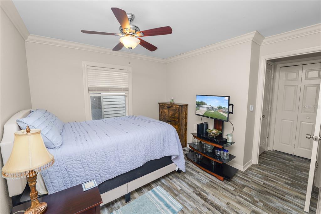 225 Lindale Street Lakeland, FL 33809 - Photo 26 of 37 a bedroom with a bed and wooden floor