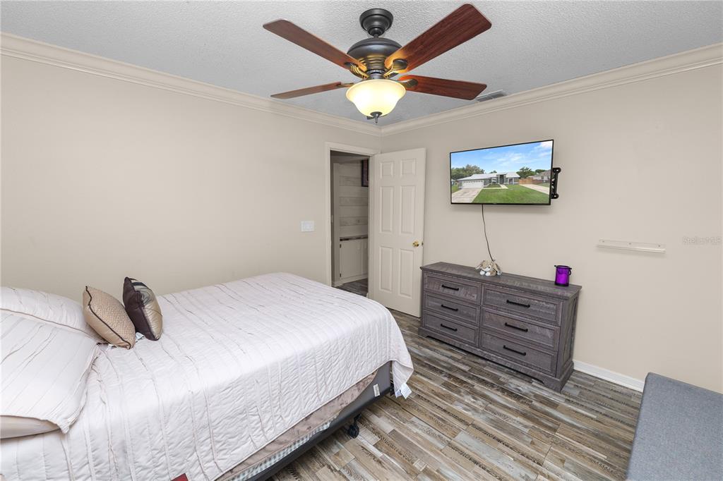 225 Lindale Street Lakeland, FL 33809 - Photo 27 of 37 a bedroom with a bed and a chandelier