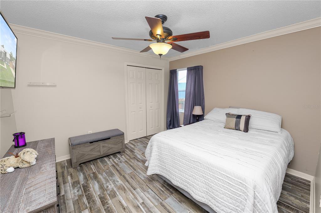 225 Lindale Street Lakeland, FL 33809 - Photo 28 of 37 a bedroom with a bed and a chandelier