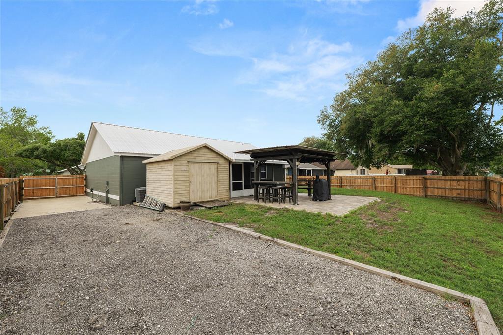 225 Lindale Street Lakeland, FL 33809 - Photo 34 of 37 a view of a house with backyard and trees