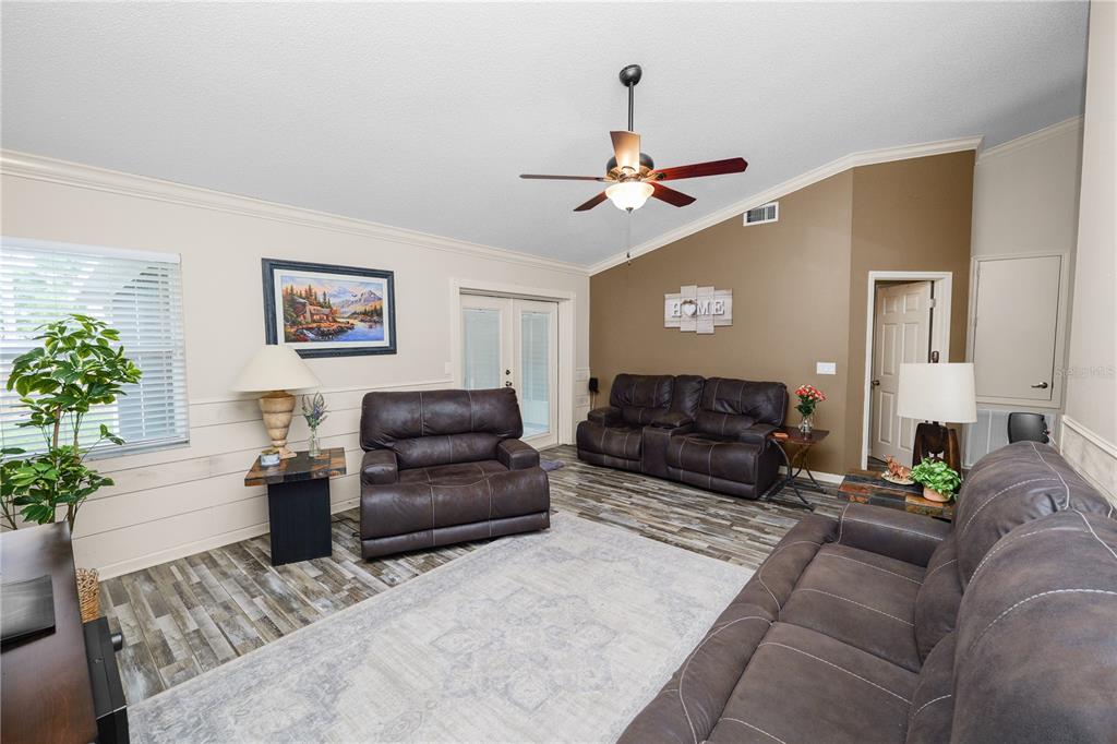 225 Lindale Street Lakeland, FL 33809 - Photo 8 of 37 a living room with furniture a couch and a chandelier