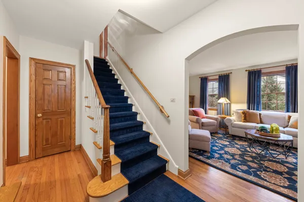 a living room with furniture fireplace and a large window