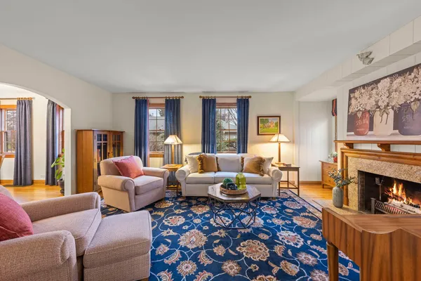 a kitchen with stainless steel appliances kitchen island hardwood floor sink stove dining table and chairs