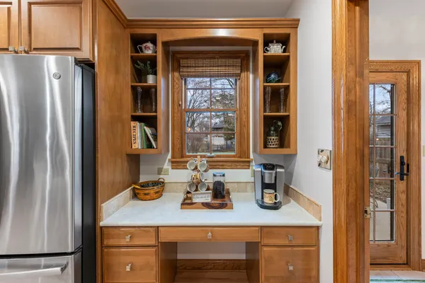 a view of a hallway with wooden floor and entryway