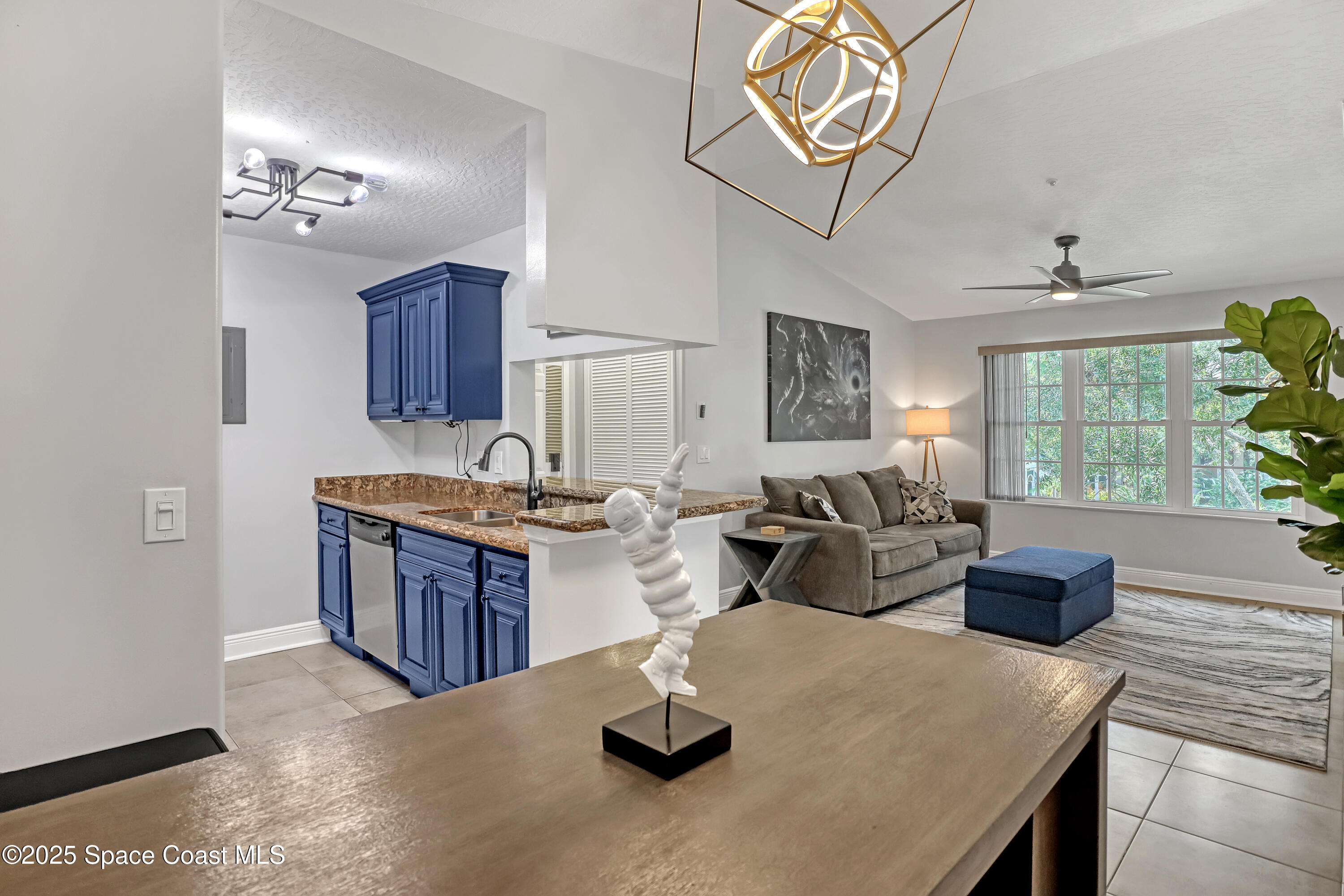 7667 North Wickham Road, Unit 224 Melbourne, FL 32940 - Photo 13 of 32 a living room with furniture and a large window