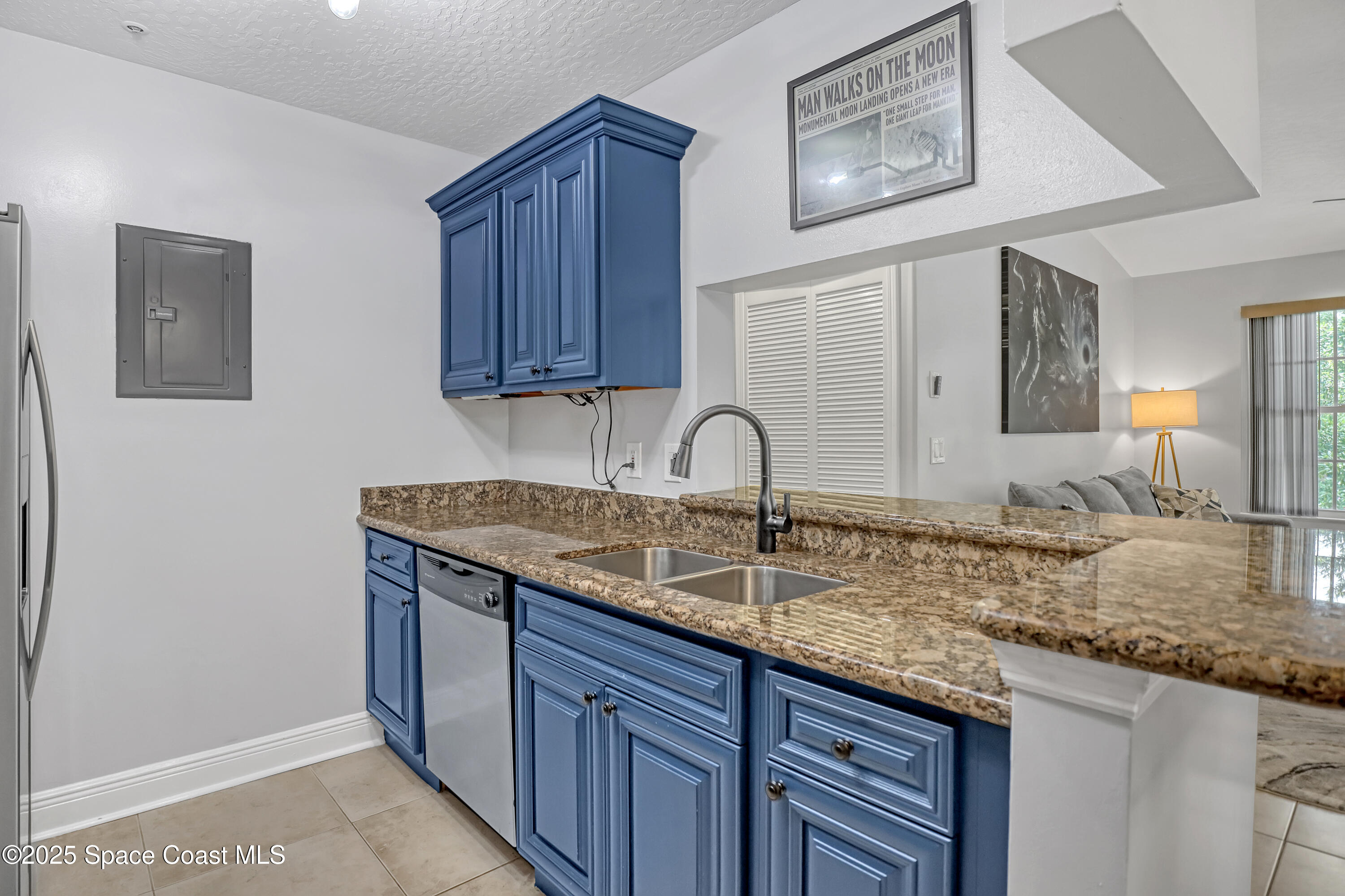 7667 North Wickham Road, Unit 224 Melbourne, FL 32940 - Photo 16 of 32 a kitchen with granite countertop a sink and cabinets
