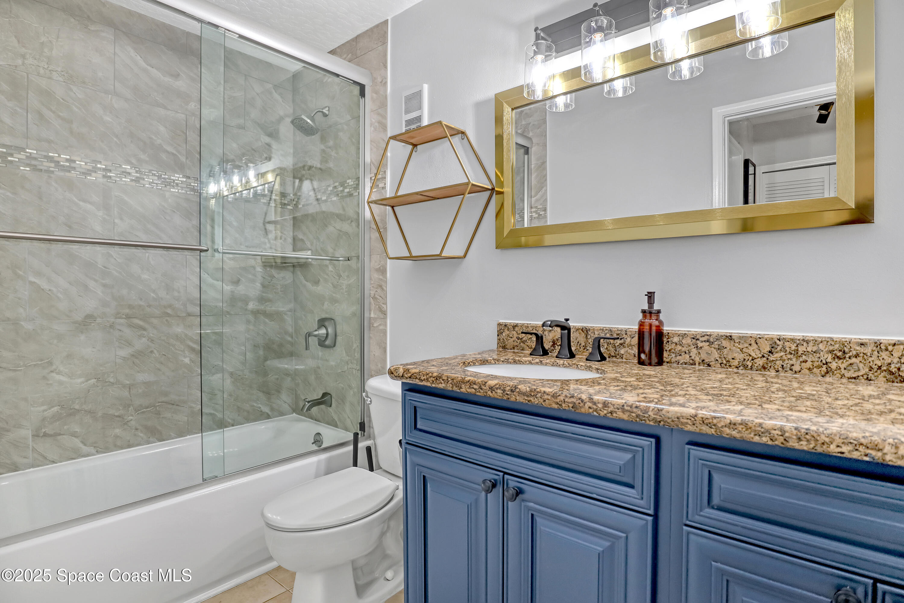 7667 North Wickham Road, Unit 224 Melbourne, FL 32940 - Photo 22 of 32 a bathroom with a granite countertop sink a toilet and shower