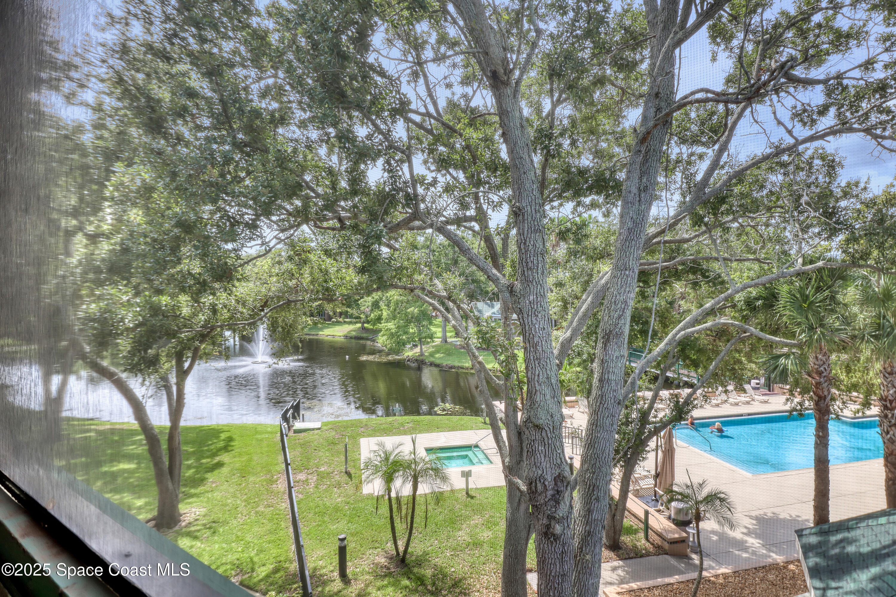7667 North Wickham Road, Unit 224 Melbourne, FL 32940 - Photo 25 of 32 a view of a yard in front of a house with large trees