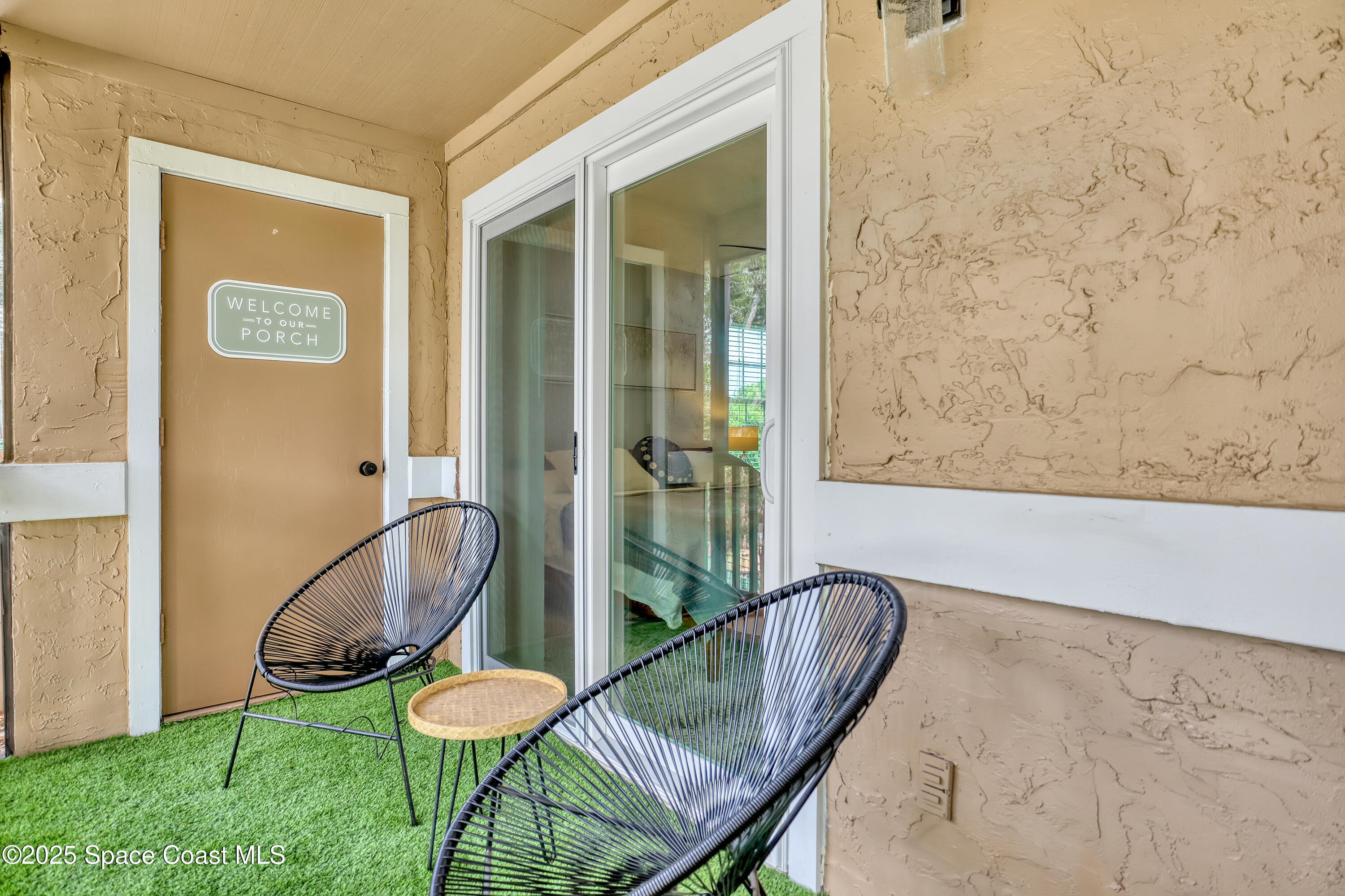 7667 North Wickham Road, Unit 224 Melbourne, FL 32940 - Photo 26 of 32 a view of a balcony with chair and potted plant
