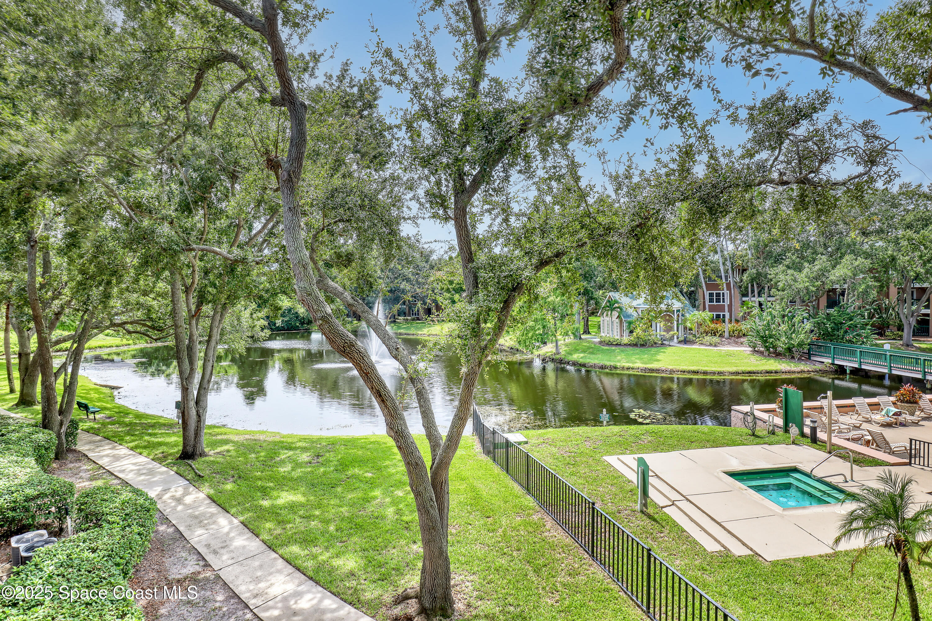 7667 North Wickham Road, Unit 224 Melbourne, FL 32940 - Photo 4 of 32 a view of a lake with a yard