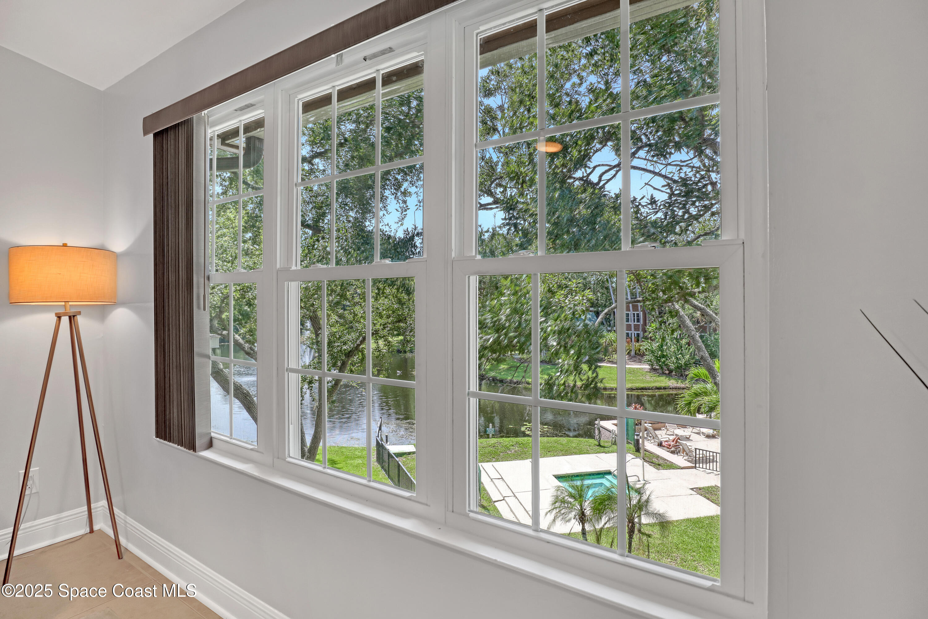 7667 North Wickham Road, Unit 224 Melbourne, FL 32940 - Photo 9 of 32 a view of a room that has a bed and a window