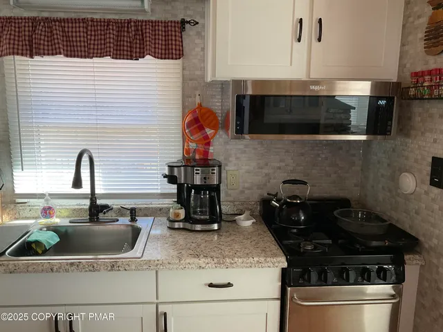 a white refrigerator freezer sitting inside of a kitchen