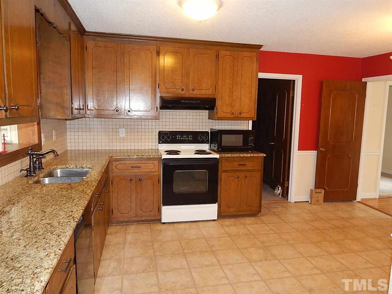 1427 Torredge Road Durham, NC 27712 - Photo 6 of 17 a kitchen with stainless steel appliances granite countertop a stove a sink and a microwave