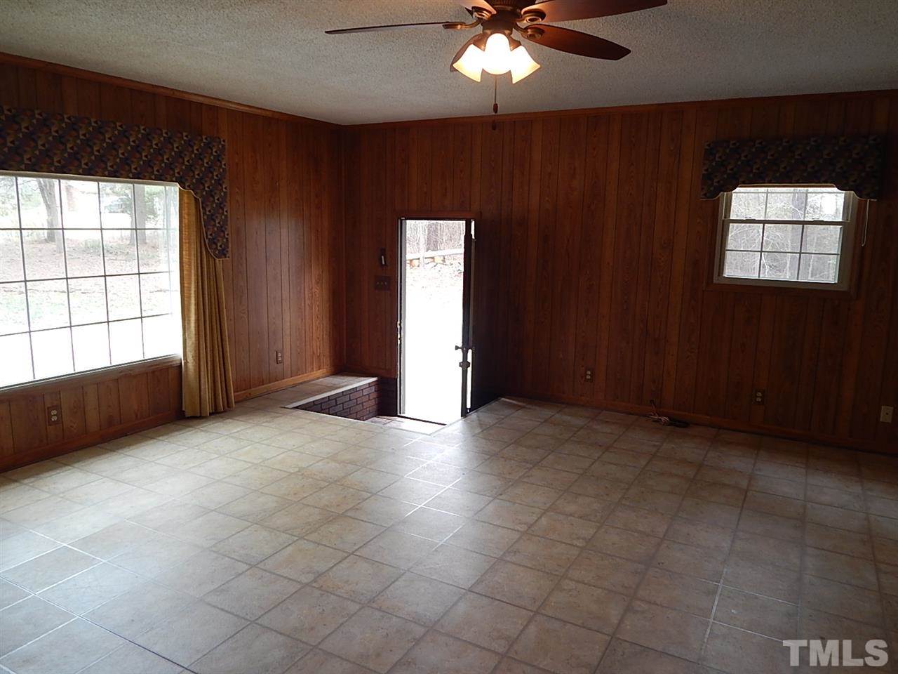 1427 Torredge Road Durham, NC 27712 - Photo 8 of 17 an empty room with chandelier fan and windows