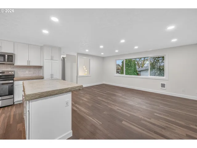 a view of a kitchen with a sink and a window
