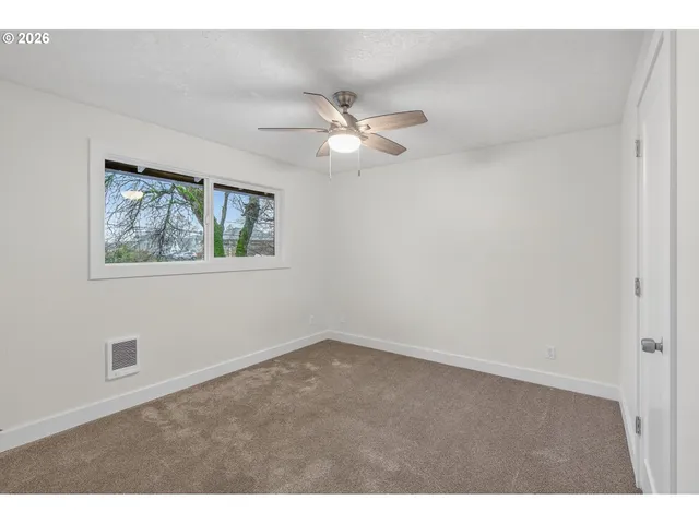 a view of an empty room with a fan