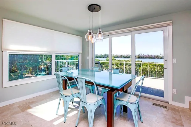 a view of a dining room with furniture large windows and wooden floor