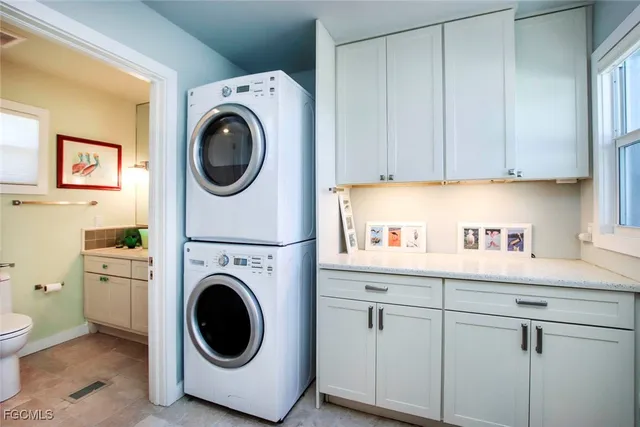 a utility room with sink dryer and washer