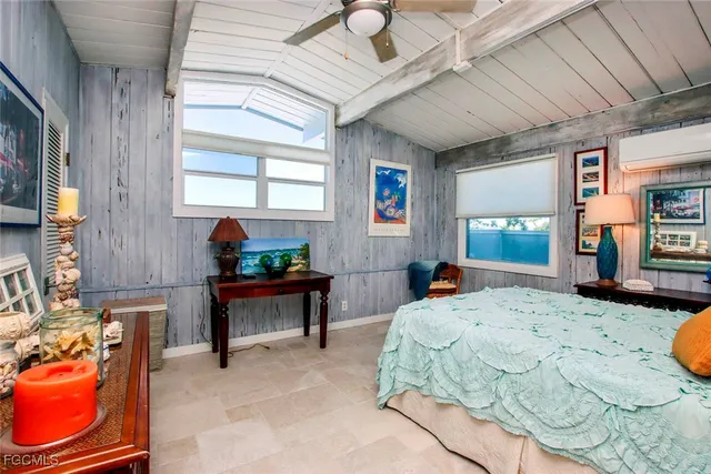 a bedroom with furniture and a window