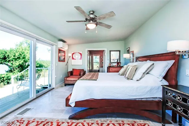 a bedroom with a bed and a large window with the outer view