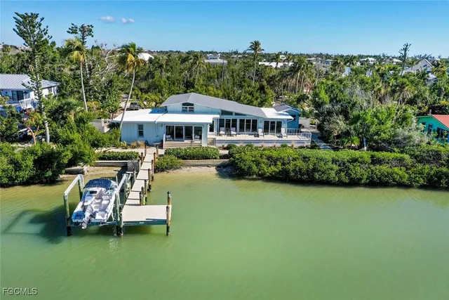 an aerial view of a house with swimming pool and garden