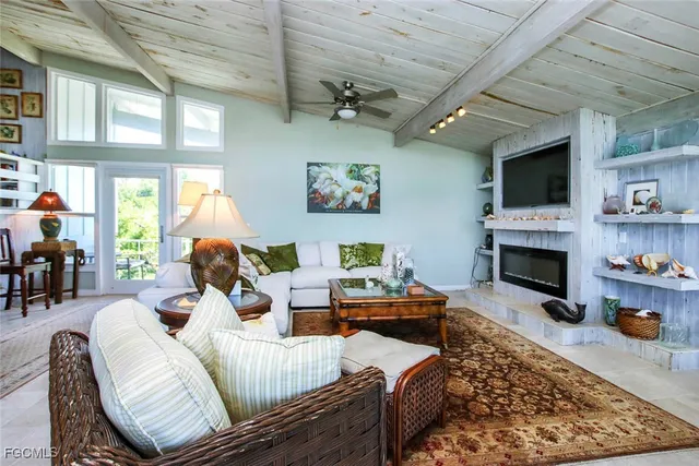 a living room with furniture fireplace and flat screen tv