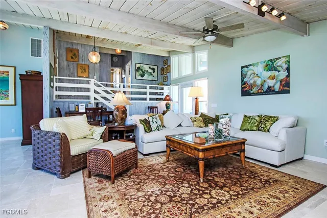 a living room with furniture a rug and a chandelier