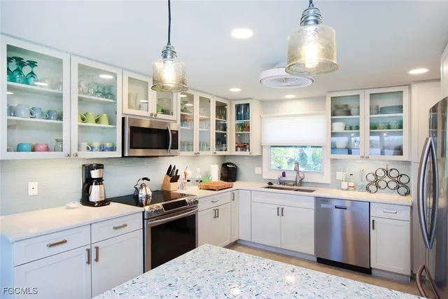 a kitchen with a sink a stove and cabinets