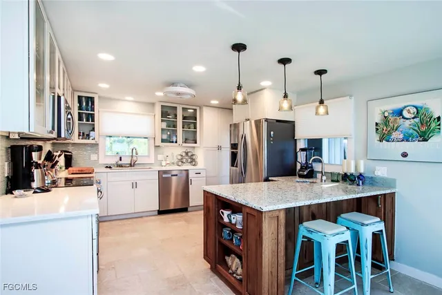 a kitchen with refrigerator cabinets and wooden floor
