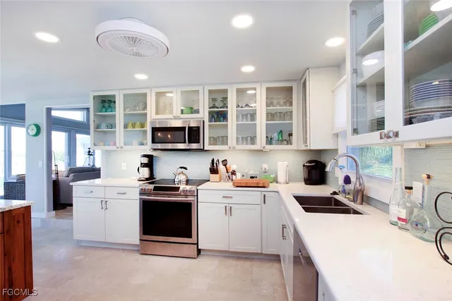 a kitchen with a sink a stove and cabinets