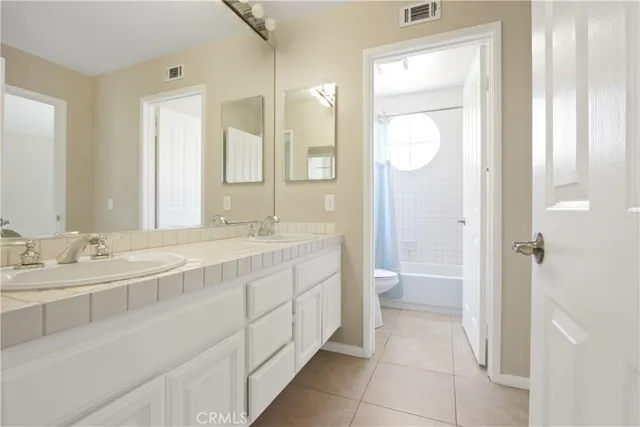 a spacious bathroom with a granite countertop sink mirror and a