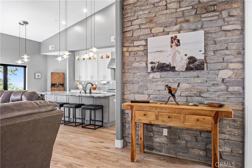 27300 Stirrup Way Tehachapi, CA 93561 - Photo 11 of 45 a room with stainless steel appliances kitchen island granite countertop a stove and a sink