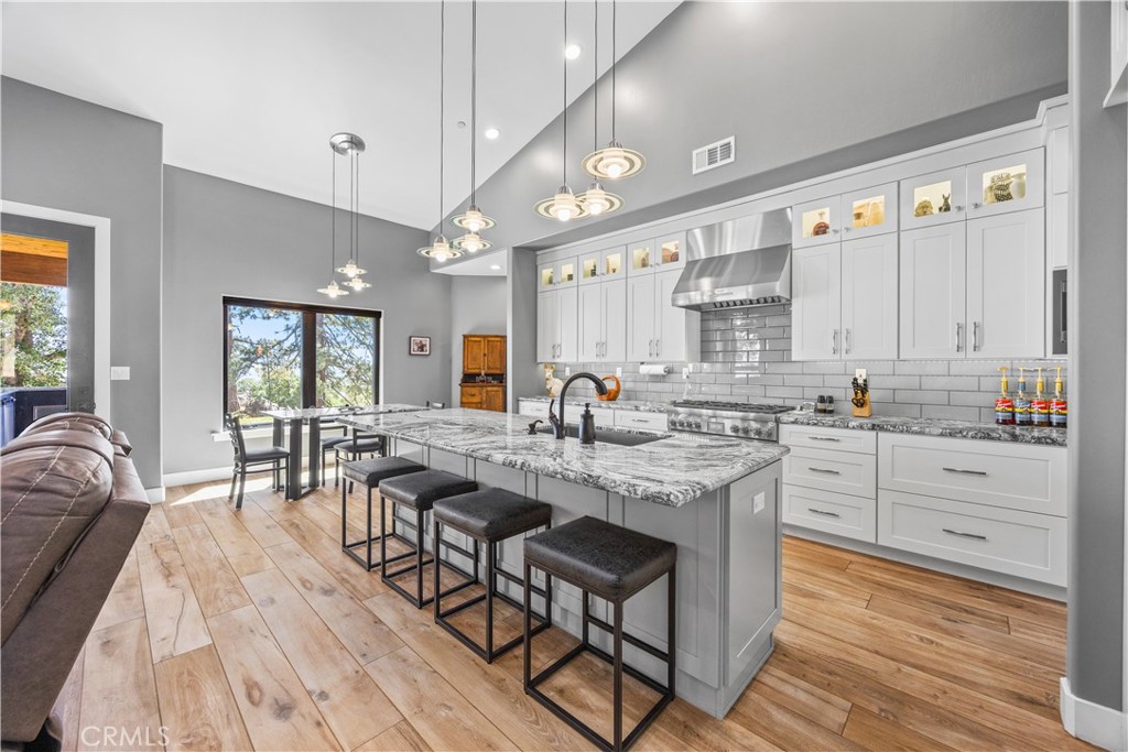 27300 Stirrup Way Tehachapi, CA 93561 - Photo 12 of 45 a large white kitchen with granite countertop lots of counter top space and furniture