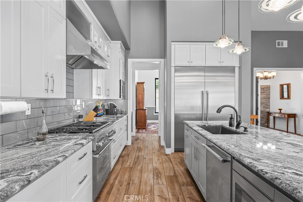 27300 Stirrup Way Tehachapi, CA 93561 - Photo 16 of 45 a kitchen with granite countertop a sink stainless steel appliances and cabinets