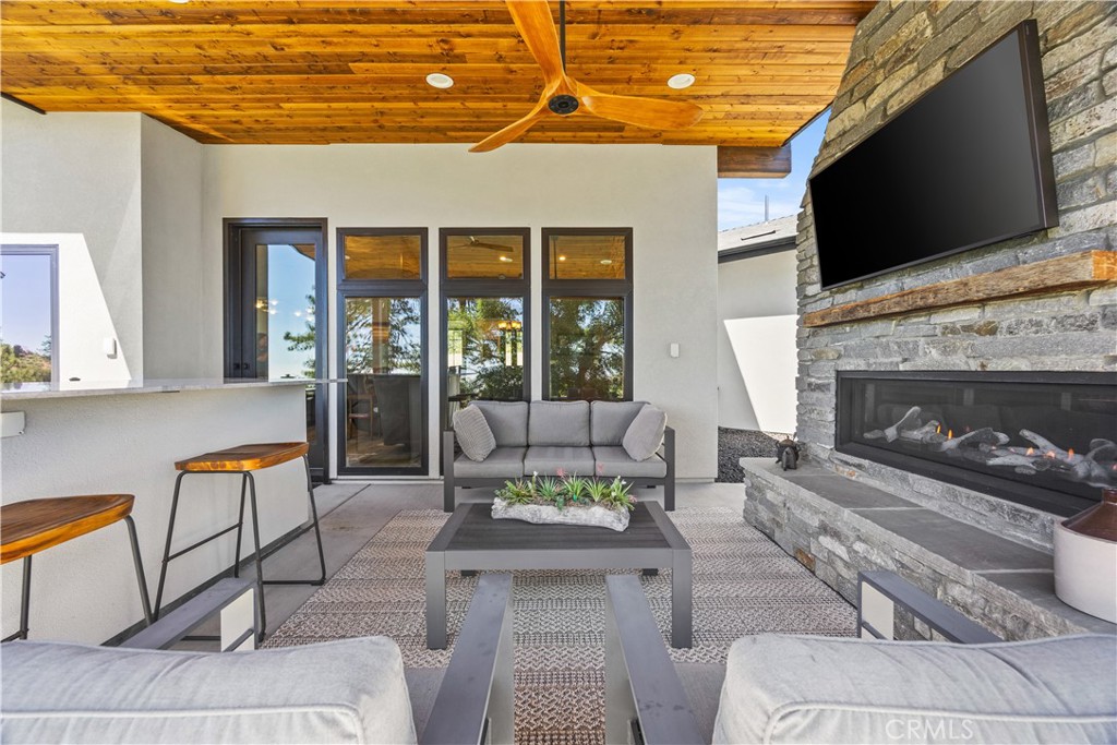 27300 Stirrup Way Tehachapi, CA 93561 - Photo 18 of 45 a living room with furniture a flat screen tv and a fireplace