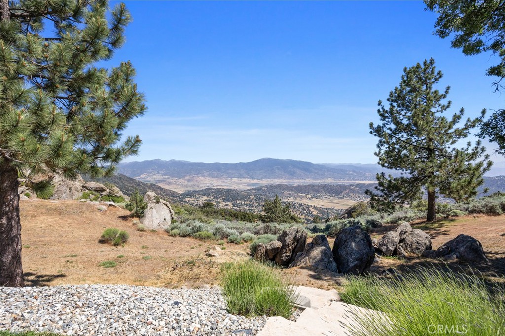27300 Stirrup Way Tehachapi, CA 93561 - Photo 21 of 45 a view of a backyard of a house with a mountain
