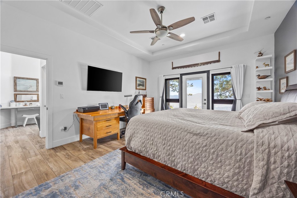 27300 Stirrup Way Tehachapi, CA 93561 - Photo 23 of 45 a bedroom with a large bed and a flat screen tv